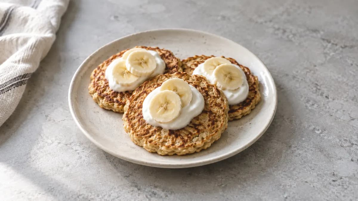Banana yogurt pancakes served in a small portion on pale stone