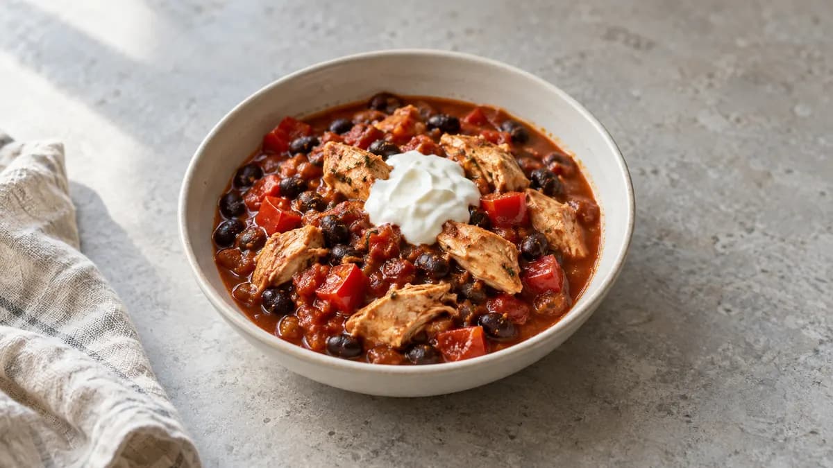 Chicken taco stew served in a small portion on pale stone