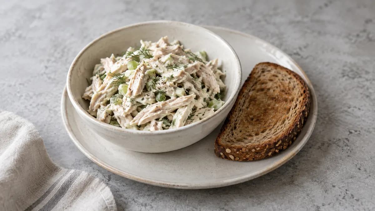 Lemon yogurt chicken salad served in a small portion on pale stone
